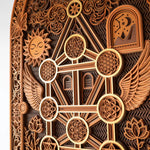 Decorative wooden panel with intricate carvings including a sun, moon, and geometric patterns.