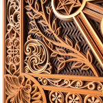 Close-up of intricate wooden carvings with floral and geometric patterns.