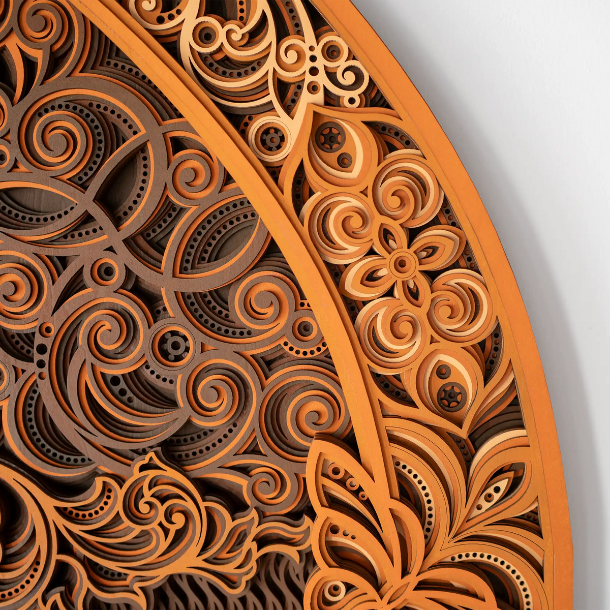 Close-up of a wooden decorative panel with intricate carvings on a white background