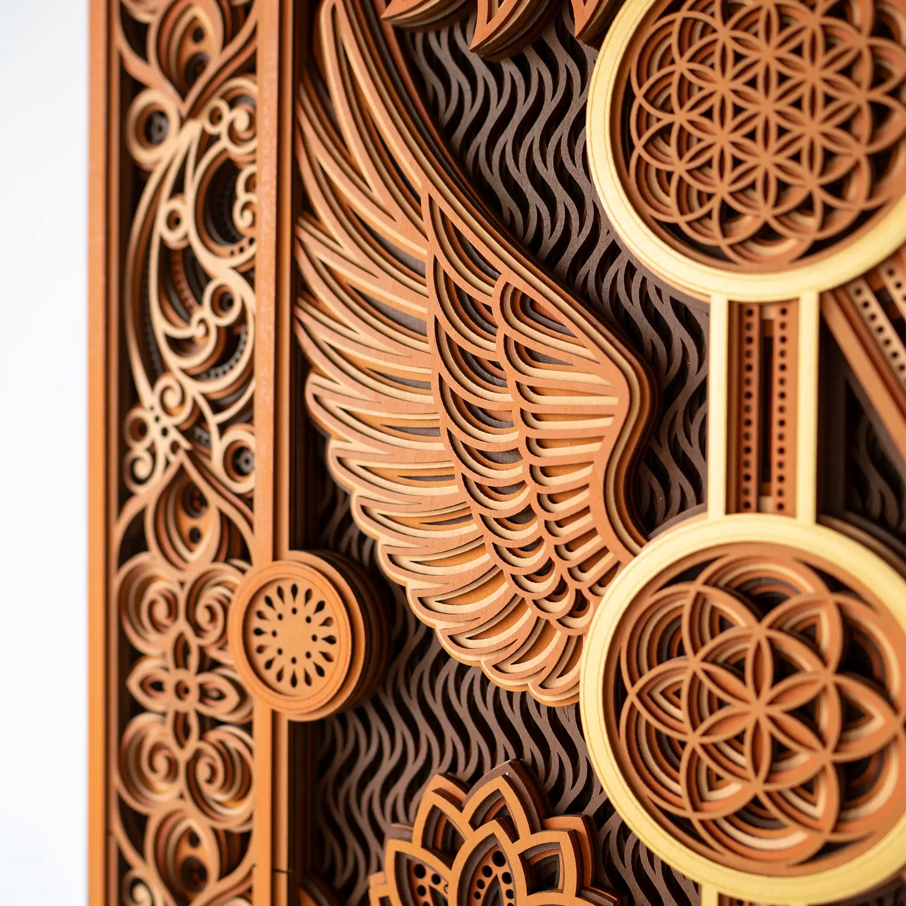 Decorative wooden panel with intricate patterns and wing design