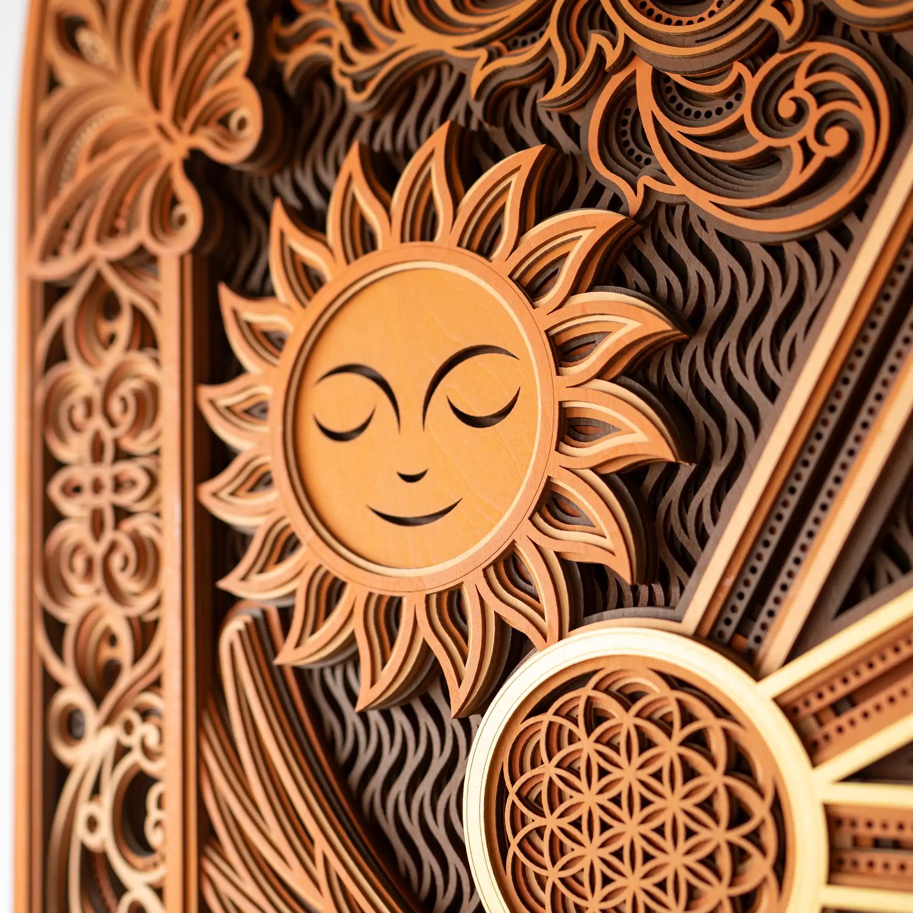 Decorative wooden panel with sun design and intricate patterns