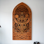 Decorative wooden wall art with intricate carvings on a white background
