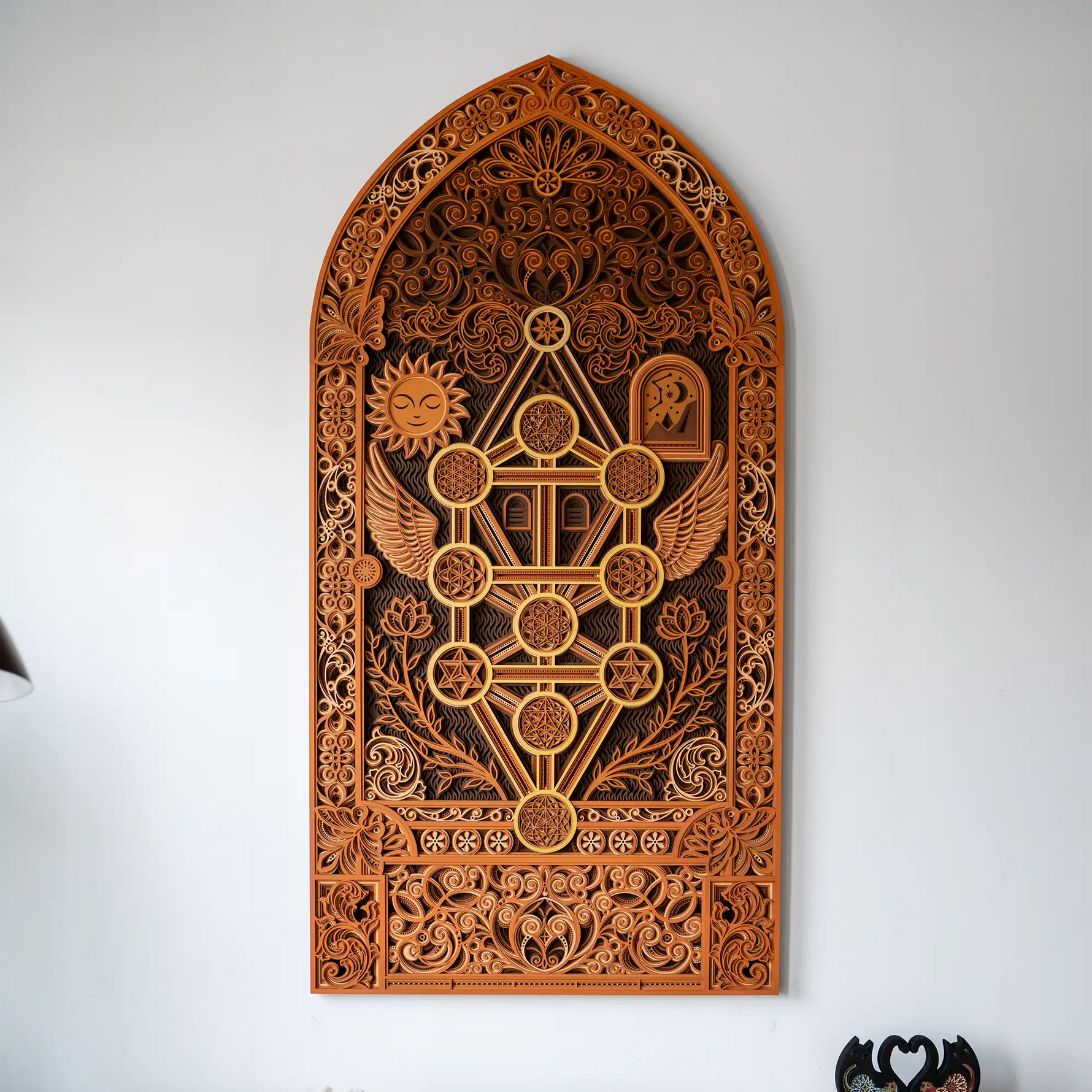 Decorative wooden wall art with intricate carvings on a white background