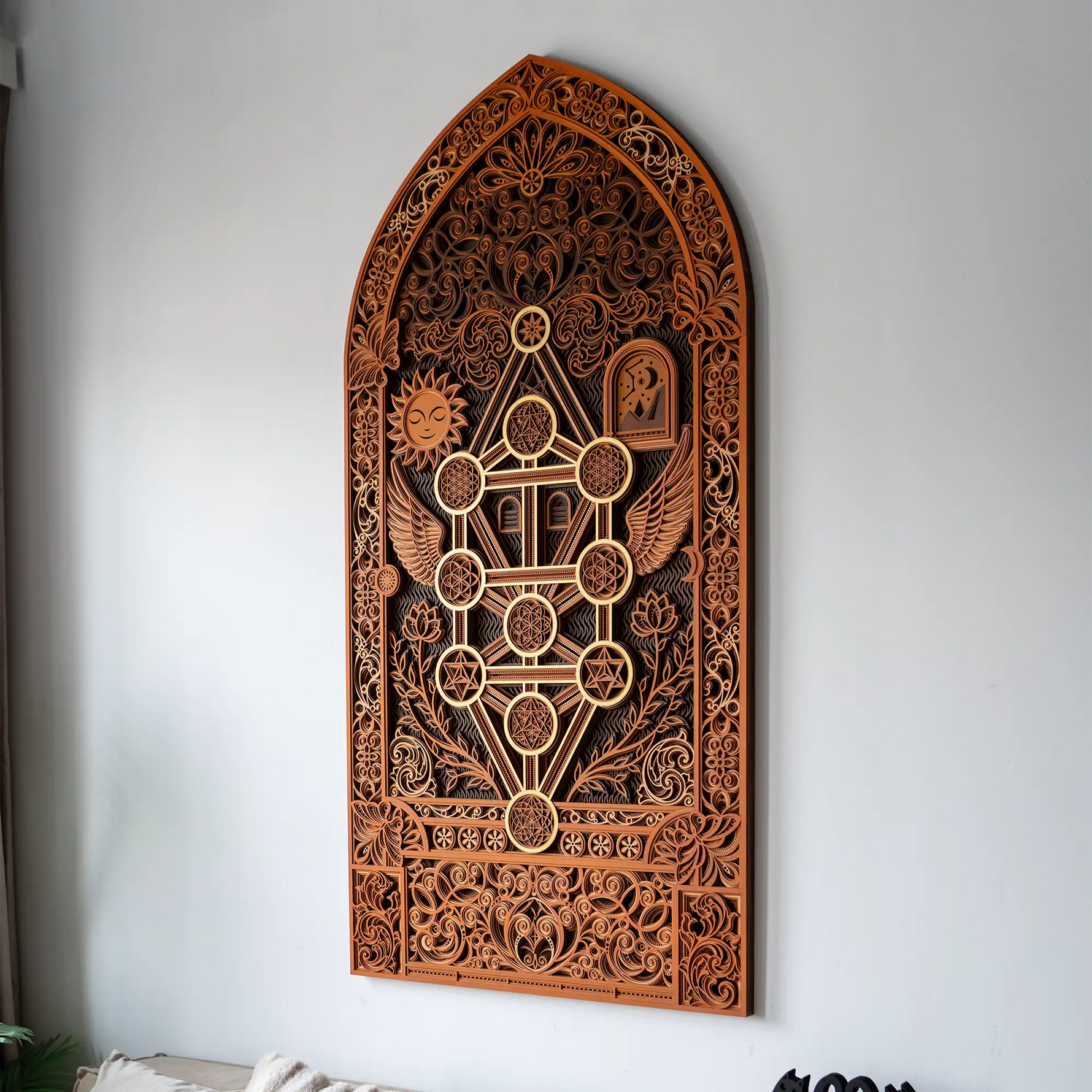 Decorative wooden wall panel with intricate carvings on a white wall.